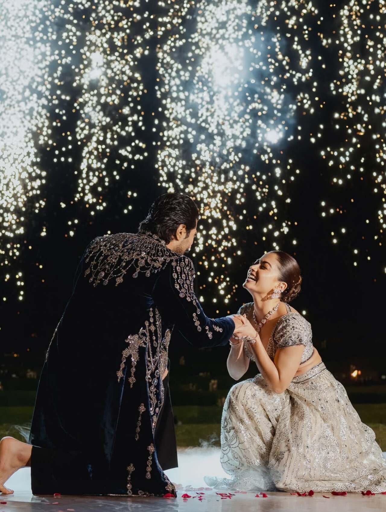 In one frame, the couple is seen smiling at each other under twinkling fairy lights, while another picture captures Vijay carrying Rashmika in his arms, during a dance performance with fireworks lighting up the background
